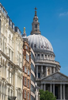 Lugate Hill Street with historic buildings and the dome of St. Paul's Cathedral in the background,