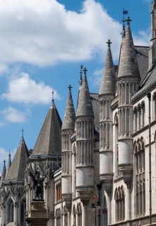Royal Courts of Justice, neo-gothic architecture with towers under blue sky, London, England, Great