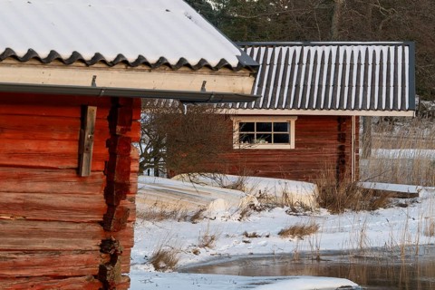 Snowy wooden huts in a winter landscape, Korpoström, Korpo or Korppo, southwestern archipelago,