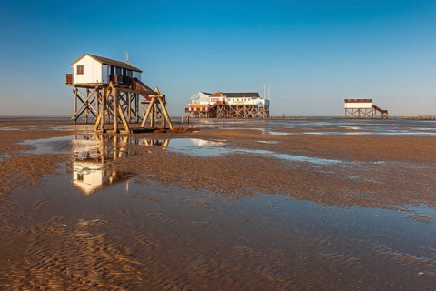Stilt houses on the beach at low tide, St. Peter-Ording, Schleswig-Holstein Wadden Sea National