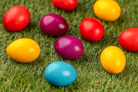 Colourful Easter eggs spread on green grass