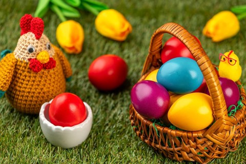 A basket of colorful Easter eggs next to a chicken figurine