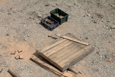 Wooden beams and 2 boxes on a construction site