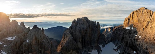 Impressive mountain peaks of the Brenta Mountains, sunrise, 360 degree alpine panorama, aerial