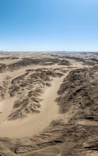 Aerial view, dry barren mountains in Moon Valley, rocky landscape ridged by erosion, Namib-Naukluft