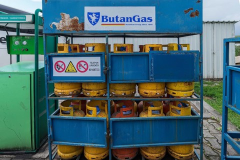 Sales rack with butane gas bottles at a gas station, Romania
