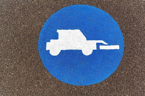 Tractor, front loader, pictogram on the asphalt, agricultural traffic, traffic signs on the dyke,