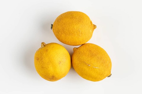 Three old lemons on a light background