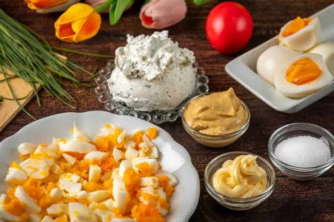 Ingredients for egg cream, such as cream cheese, sliced eggs and herbs
