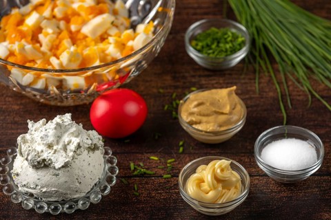 Eggs, cream cheese and spices for a spread in bowls