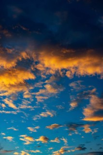 Aircraft contrails with red clouds, sunrise, Upper Austria