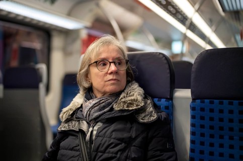 Elderly woman, portrait, thoughtful, glasses, gray hair, coat, scarf, winter clothes, sitting in