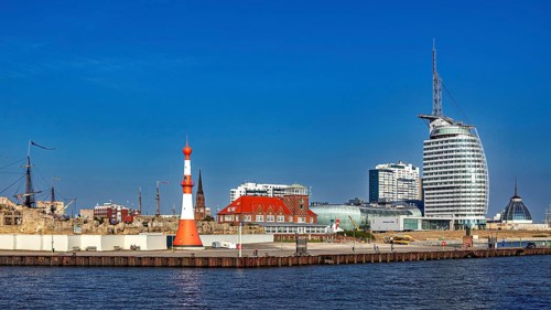 Lighthouse and modern buildings at the harbor under clear skies, The City of Bremen