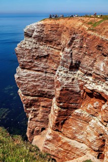 Red cliffs under a clear sky with the blue sea, the high-seas island of Heligoland in the North Sea