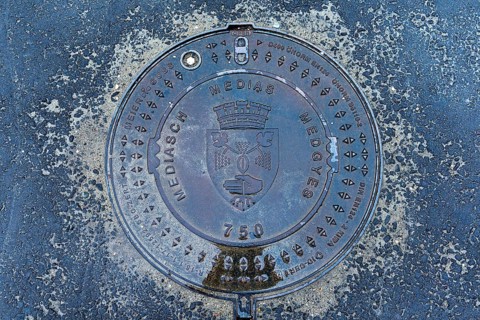 Manhole cover with city coat of arms of Medias, Romania