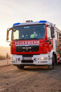 A MAN fire engine with the inscription 'FIRE DEPARTMENT' is parked on the side of the road when the