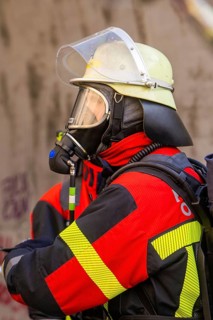 Firefighter wearing a respirator and protective clothing in a tunnel during an operation, fire