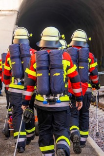 Firefighters in protective clothing and equipment on their way into a tunnel, fire brigade exercise