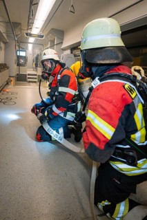 Firefighters are getting ready for a mission inside a train, fire brigade exercise on the Hermann