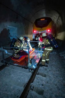 Firefighters carry out a rescue on rails in a tunnel, fire brigade exercise on the Hermann Hesse