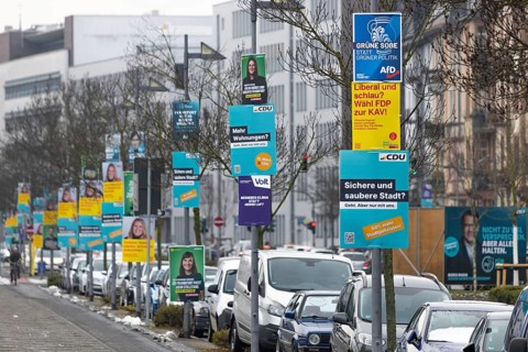 Numerous election posters for the 2026 local elections are hanging one behind the other on several