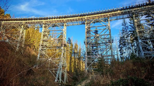 Towering metal bridge old railway bridge over a forest, illuminated by the sun, Ziemestalbrücke,