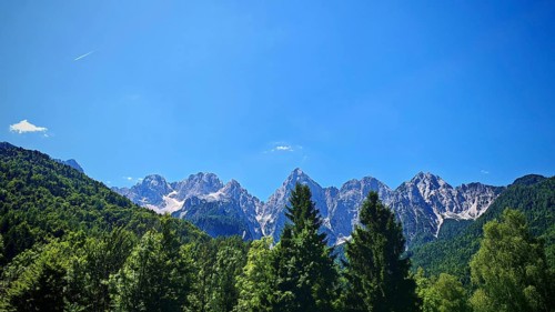 Mountain range with wooded foreground and blue sky, Slovenia