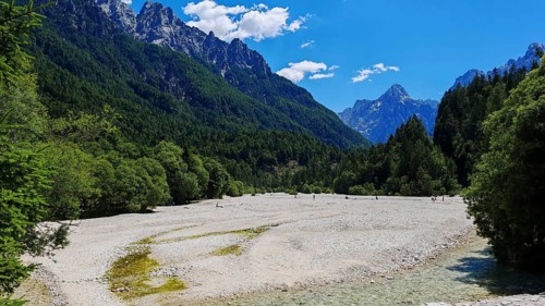 Wide valley with mountains and riverbed in the foreground, Slovenia