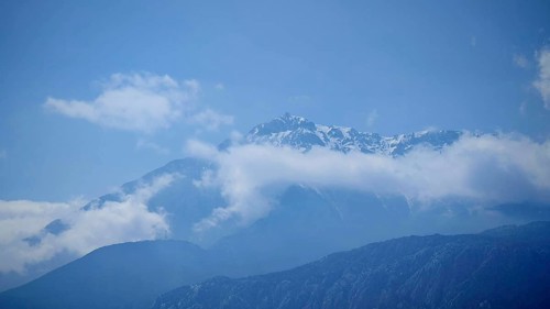 Snowy mountain peaks of Tahtali Dagi jut out of surrounding clouds, Lycia, Turkey