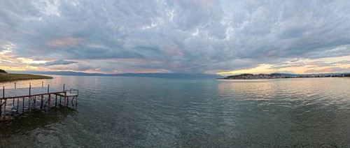 Panoramic view of a lake at sunset, with a jetty in the foreground, Lake Ohrid, North Macedonia