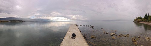 Panoramic picture of a long jetty over a wide, calm lake, Lake Ohrid, North Macedonia
