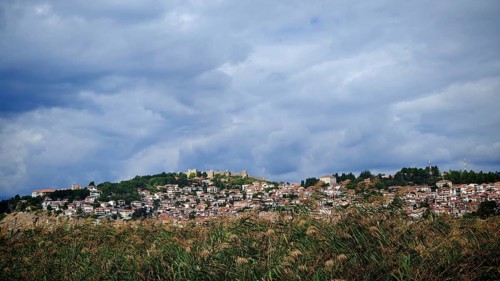 A city on a hill with a wide view of clouds and vegetation below, Ohrid, North Macedonia