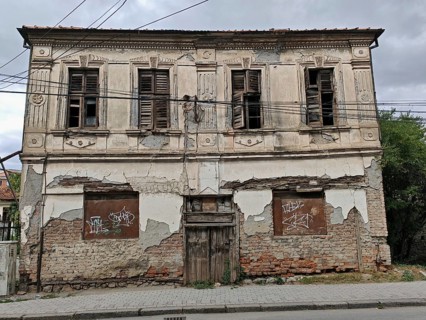 An old, dilapidated building with closed shutters and crumbling façade, Ohrid, North Macedonia