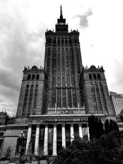 Majestic skyscraper Palace of Culture in historical style in black and white under cloudy sky,