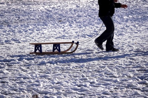 Sled in snow pulled by a man, winter, Germany