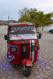 Red tuk tuk or tricycle taxi in Flores, Petén Department, Guatemala