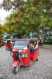 Red tuk tuks or tricycle taxis in Flores, Petén Department, Guatemala