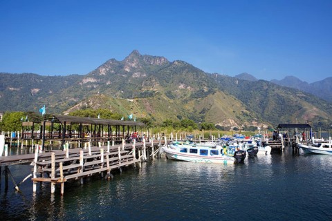 Colourful boats in the port of San Juan la Laguna, the mountains behind, Atitlán, Sololá