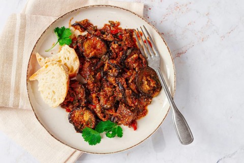 Stewed meat with eggplant is a Georgian dish, on a light background, homemade, no people