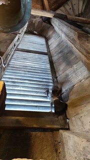 View into a wooden tower with a pigeon (columbidae) at the window, Thuringia