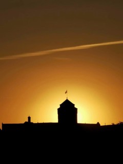 Silhouette of a historic building, Rosenberg Fortress with dramatic sunset in the background,