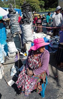 Mayan woman in traditional clothing selling charcoal at the market in Sololá, Highlands, Sololá