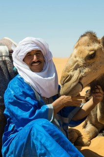 Berbers and dromedaries in the sand dunes, near Merzouga, Meknès-Tafilalet region, Erg Chebbi,