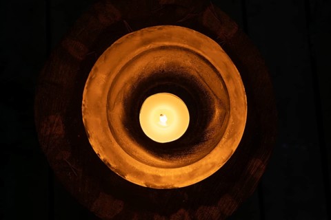 Ice bowl illuminated by a burning tea light, winter, Finland