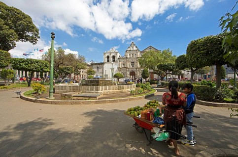 Parque Centroamérica or Parque Central, a Mayan woman in traditional dress selling oranges, in the