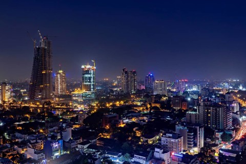 Illuminated nighttime skyline with numerous skyscrapers and sparkling city lights