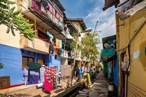 Colourful narrow neighborhood alleyway with clotheslines and a homely atmosphere