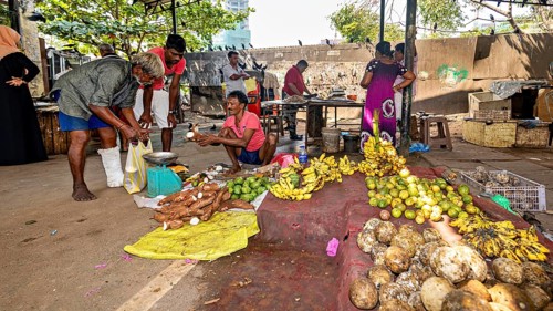 Lively open-air market with tropical fruit and vegetable shops