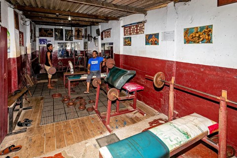 Classic gym with dumbbells and artwork on the wall, rustic ambiance