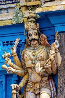 Detailed and colorful sculpture of a deity at a temple